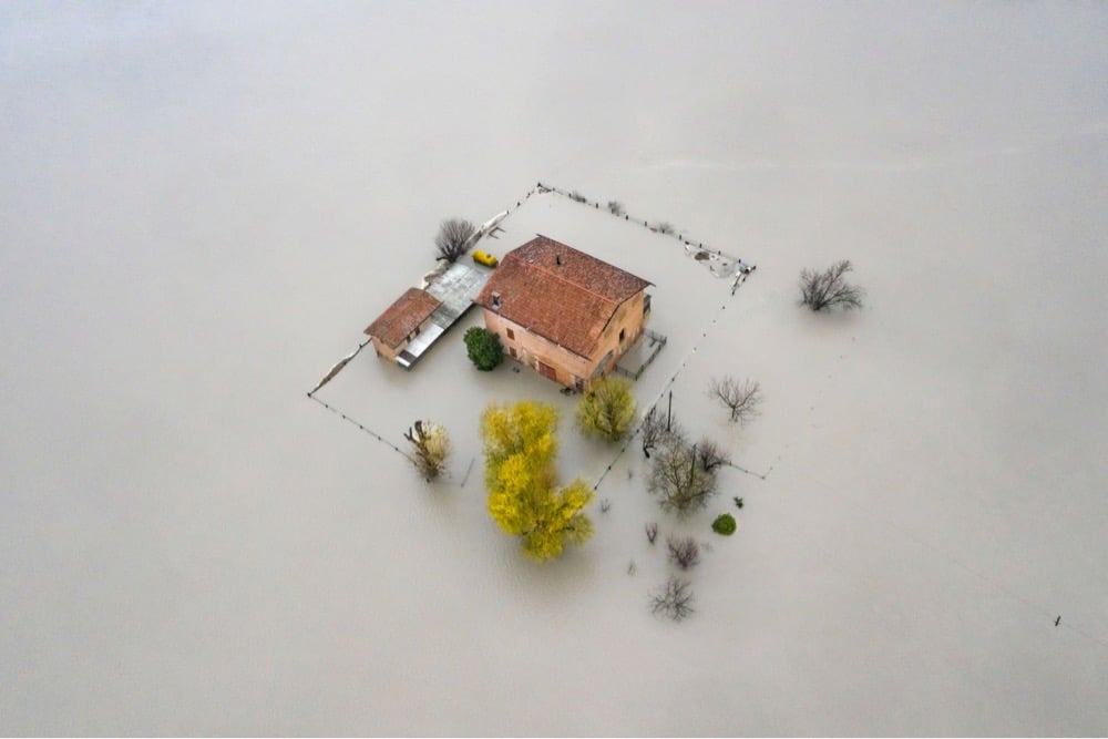 an overhead view of a house surrounded by flood waters