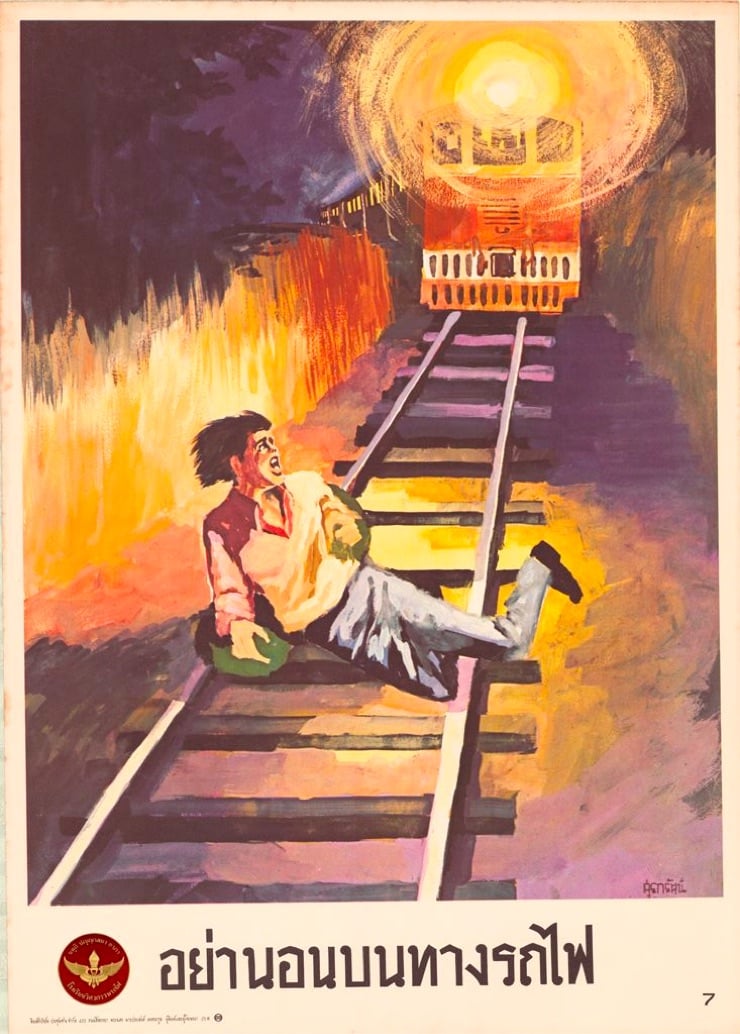 a Thai train safety poster that shows someone laying on the tracks in front of an oncoming train